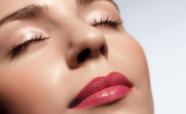 Young woman wearing make-up, eyes closed, close-up